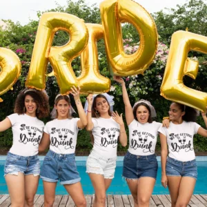 Bride and friends wearing “So We’re Getting Drunk” T-shirts at a hen party